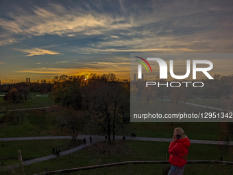 Woman Talks On Smartphone While Sunset