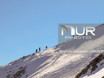 Hikers On Snowy Slope