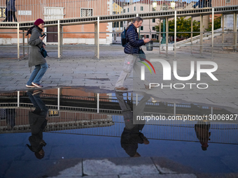People Walking While Using Smartphones In Venice