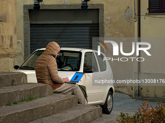 Man Sits On Steps Working With Laptop