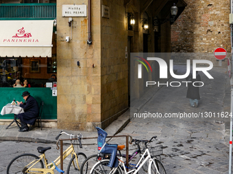 Senior Man Smoking And Drinking Wine In Outdoor Cafe