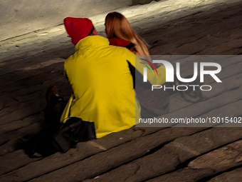 Close-up Of Couple Embracing On Stone Steps At Night