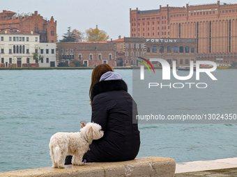 Woman And Dog At Grand Canal In Venice On Overcast Day