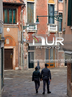 Guardia Di Finanza Officers Walk Through Alleyway In Venice