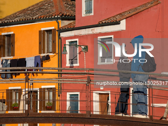 Young Couple Gazes On Bridge Against Colorful Burano Houses