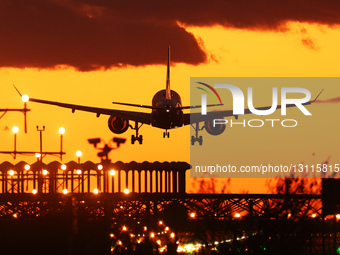 Aircraft Land At Barcelona Airport At Sunset