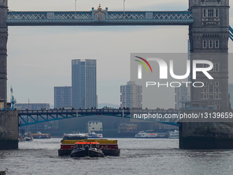 A Cory Waste Tug Navigating The River Thames Near Tower Bridge In London