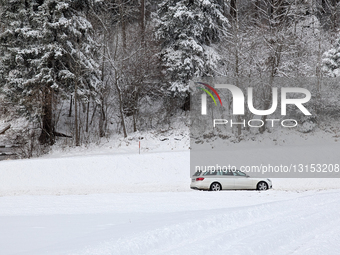 Car Drives Along Snow-Lined Roads In Tyrol