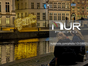 Evening Reflections And People By The Gent Sign At A Channel Waterfront In Ghent