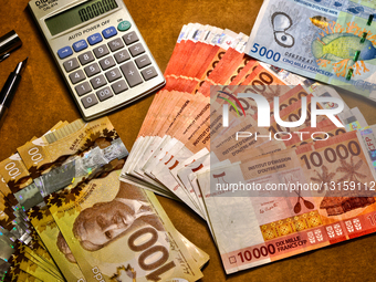 Woman Counting Canadian Dollars And French Pacific Francs And Calculating The Exchange Rate