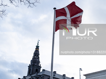 A Danish Flag Flutters Outside Christiansborg Palace In Copenhagen