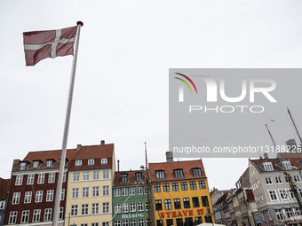 A Danish Flag Flutters In Nyhavn In Copenhagen
