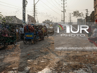 Shopkeeper Sprays Water To Reduce Dust Amid Rising Air Pollution