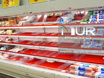 Shoppers browse partially empty shelves at an H-E-B grocery store in Frisco, Texas ahead of a forecast winter storm.