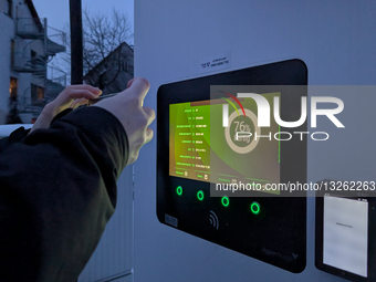 Close-up Of A Person Photographing An EV Charging Monitor