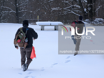 Men Walking Through Snow In German Park