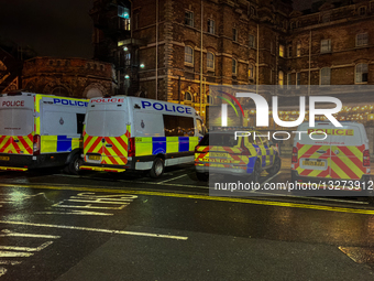 UK Police Vehicles In Front Of An Illuminated Building In York At Night