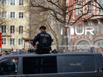 Police Officer Sitting On Police Vehicle Monitoring Demonstration In Munich