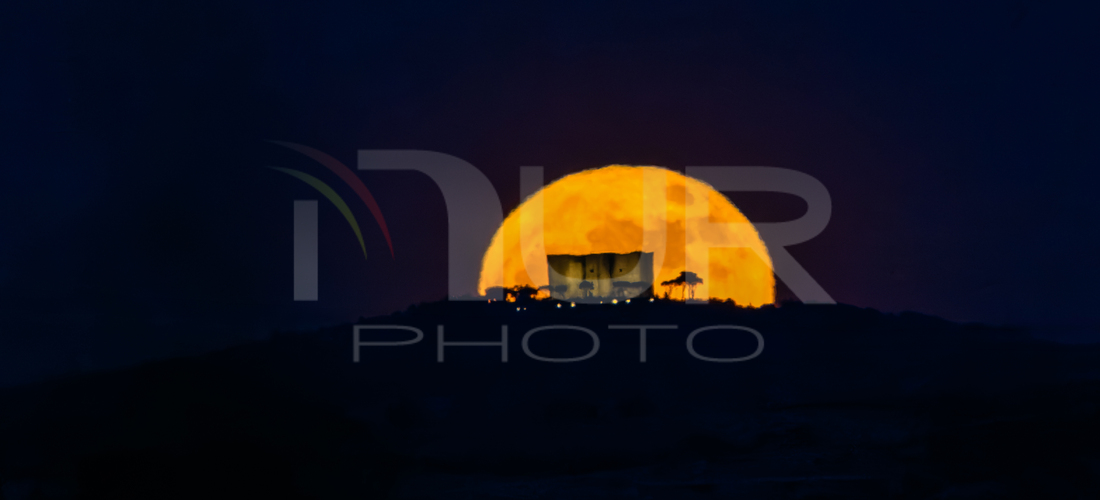 Editorial photography: A Blue Moon is visible behind Castel del Monte, photographed 18 km from the castle, between Canosa and Andria, Italy, on May 31, 2026. The B...