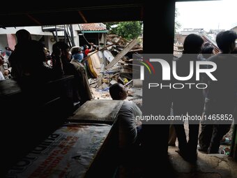 An Excavator Demolishing A House In A Slum Area In Jakarta