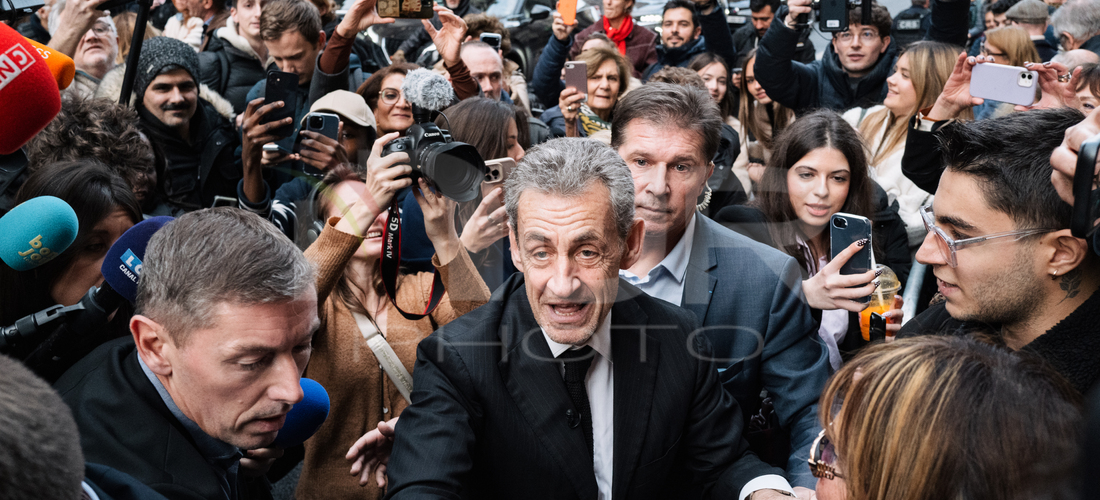 Editorial photography: Jean-Marc Morandini, a radio and television host, watches Nicolas Sarkozy's arrival during the signing of his book ''Diary of a Prisoner'' o...