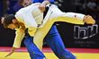 Martin Matijass (blue) of Germany competes against Lasha Bekauri of Georgia during the tea...