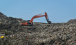 People are working in a garbage yard on the outskirts of Kolkata, India on 21 May 2023. 