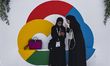 Women standing next to the Google Cloud logo at the launching event of Google Cloud region...