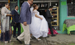 In the centre, a bride outside the Parish of the Virgin of the Assumption in Amecameca, St...
