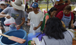 A family hands out water at the Ex Convento de Culhuacan in Iztapalapa, Mexico City, on th...