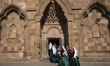 Young Iranian women dressed in traditional Iranian-Turkish attire walk into the historic S...