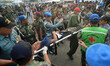 Indonesian security personnel assist members on a stretcher due to illness of the archipe...