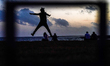 A man jumps for a picture at the Galle Face promenade in Colombo, Sri Lanka, on July 19, 2...