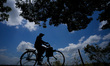 A man rides a foot cycle on the village road in Galgamuwa, Sri Lanka, on August 5, 2023. 