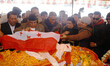 Senior leaders of Nepali Congress party lay the party flag on the body of late former Prim...