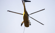 Helicopters help with the fire suppression effort during a large and fast-moving wildfire...