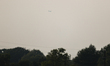 A firefighting aircraft is seen in the distance through the wildfire haze near Huntsville...