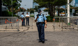 Police officers standing guard outside the legislative council complex on October 25, 2023...