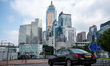 A car driving in a roundabout in front of office buildings on October 25, 2023 in Hong Kon...