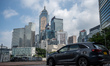 A car driving in a roundabout in front of office buildings on October 25, 2023 in Hong Kon...