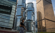 A women walks pass office buildings on October 25, 2023 in Hong Kong, China. John Lee toda...