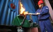 YANTAI, CHINA - OCTOBER 25, 2023 - A worker puts a torch into a heating boiler at a heat c...