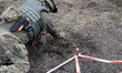 KHARKIV REGION, UKRAINE - OCTOBER 24, 2023 - A sapper cleans the space over a landmine as...