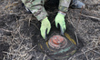 KHARKIV REGION, UKRAINE - OCTOBER 24, 2023 - A sapper defuses an anti-tank mine as a conso...