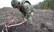 KHARKIV REGION, UKRAINE - OCTOBER 24, 2023 - A sapper marks the place where an anti-tank m...