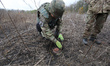 KHARKIV REGION, UKRAINE - OCTOBER 24, 2023 - A sapper defuses an anti-tank mine as a conso...