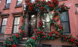 Skeletons crawl up the exterior of this Greenwich Village townhouse covered with roses in...