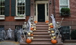 Skeletons and pumpkins stand guard on the stairs of a Greenwich Village townhouse in New Y...