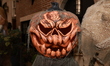 A closeup of a jack-o'-lantern outside a Carnegie Hill townhouse in New York, New York, Th...
