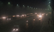Traffic moves along a highway through a layer of smog in New Delhi, India on November 1, 2...